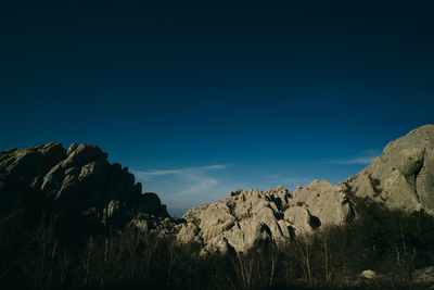 Scenic view of mountain against blue sky