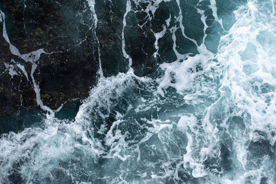 Full frame shot of waves splashing on rocks