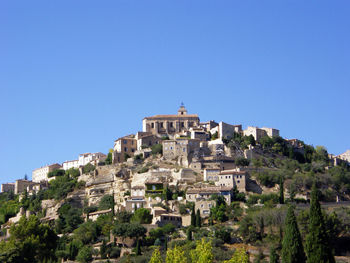 View of cityscape against blue sky