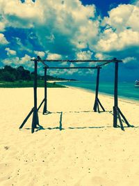 Scenic view of beach against cloudy sky