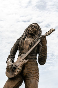 Low angle view of statue against sky