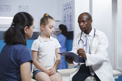 Doctor examining patient at clinic