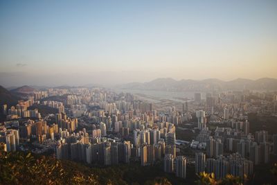 Aerial view of buildings in city against clear sky