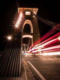 Light trails on bridge in city at night