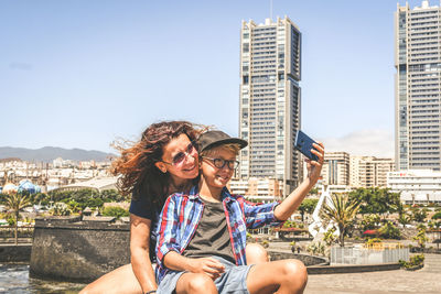 Son taking selfie with mother outdoors