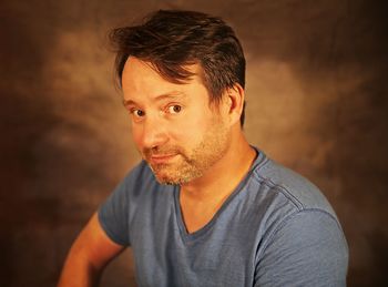 Portrait of smiling man against wall