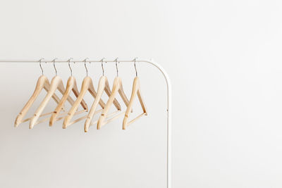 Wooden hangers on the white modern open rack, copy space for your text or brand.