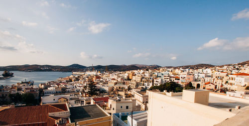 High angle view of townscape by sea against sky