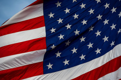 Low angle view of flag against blue sky