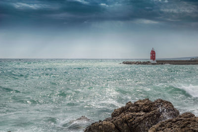 Scenic view of sea against cloudy sky