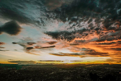 Dramatic sky over landscape during sunset