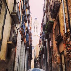 Narrow alley amidst buildings in city