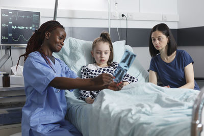 Nurse showing medical x-ray to patient