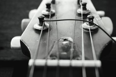 Close-up of guitar headstock on table