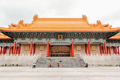 Group of people outside temple against building