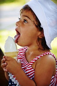 Close-up of cute girl licking ice cream