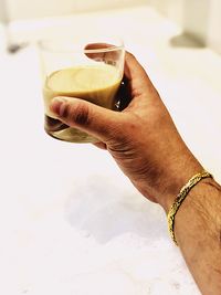 Midsection of woman drinking glass