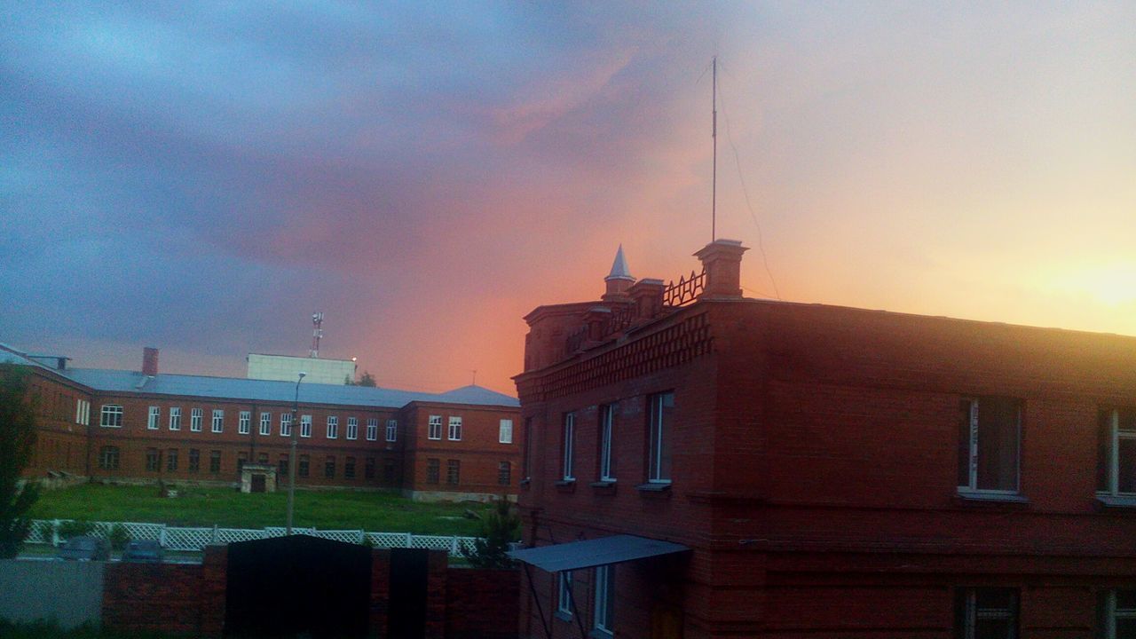 building exterior, architecture, built structure, sky, sunset, cloud - sky, residential structure, residential building, building, house, city, low angle view, cloudy, dusk, outdoors, orange color, cloud, street light, window, no people