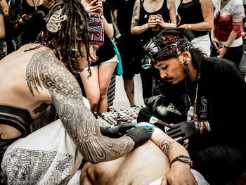 Rear view of people sitting outdoors