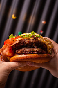 Close-up of hand holding burger