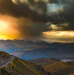 Scenic view of dramatic sky over landscape during sunset