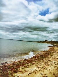 Scenic view of sea against cloudy sky