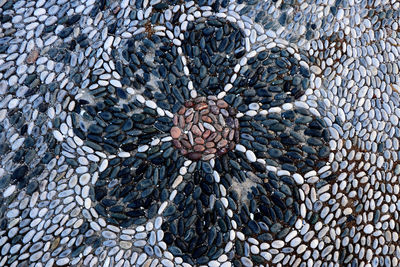 High angle view of pine cone on pebbles