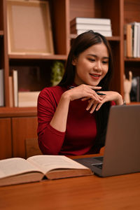 Young woman using laptop at home