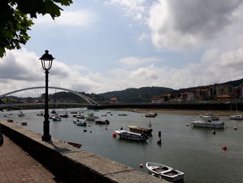 Boats in river with buildings in background