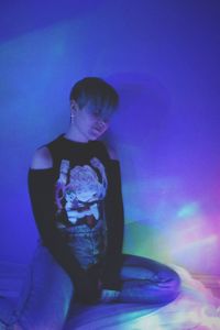 Side view of young woman looking away against clear sky