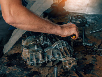 Cropped hand of man welding metal