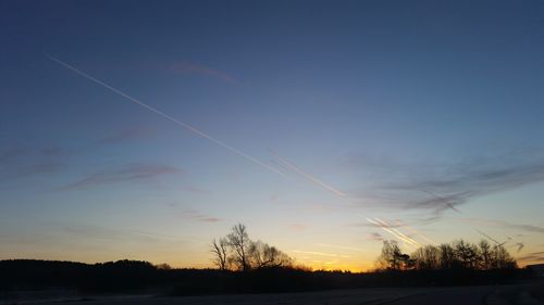 Low angle view of silhouette trees against sky during sunset