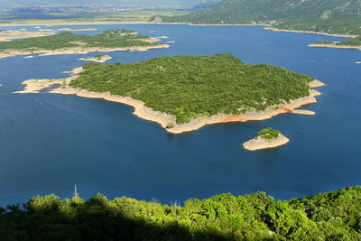 High angle view of trees by sea against sky