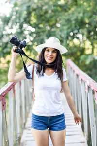 Portrait of a smiling young woman standing outdoors