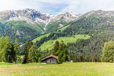 Scenic view of field and mountains against sky