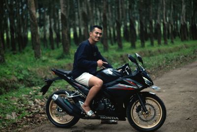 Young man riding bicycle on land