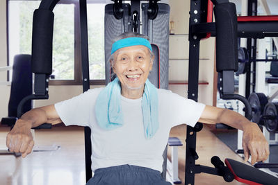 Portrait of confident senior man exercising in gym