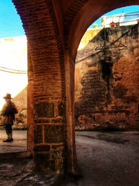 Man seen through arch bridge