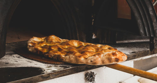 Production of baked bread with a wood oven in a bakery.