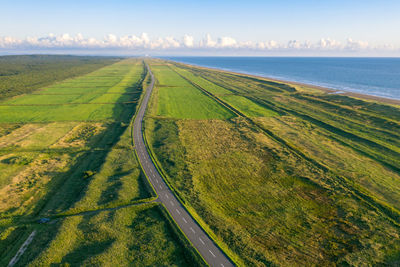 Scenic view of land and sea against sky