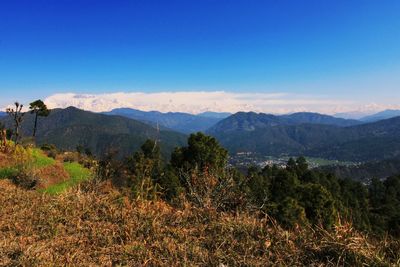 Scenic view of mountains against clear blue sky
