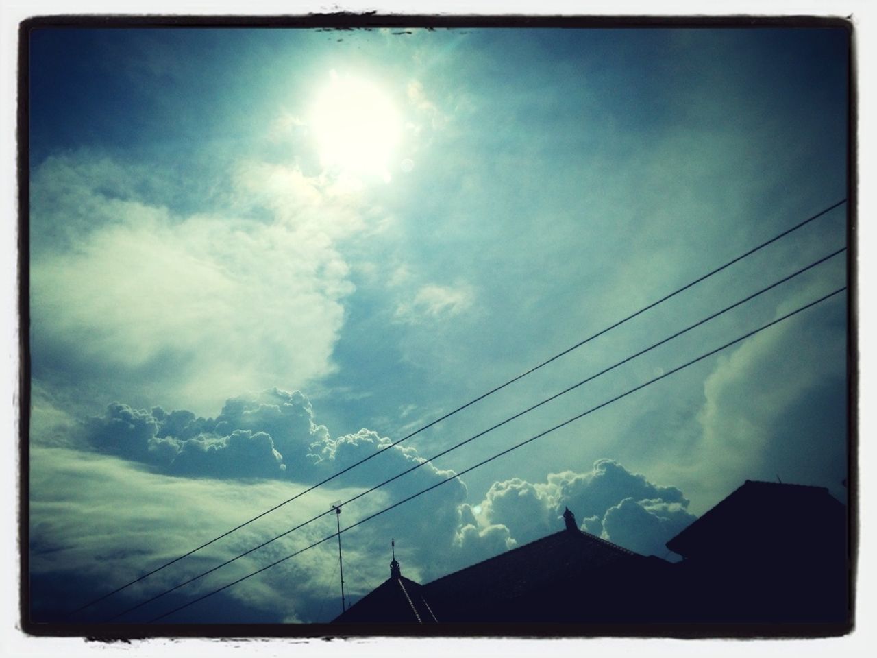 low angle view, sky, power line, transfer print, cloud - sky, sun, cable, electricity, power supply, silhouette, electricity pylon, cloud, auto post production filter, sunbeam, sunlight, connection, cloudy, nature, power cable, built structure