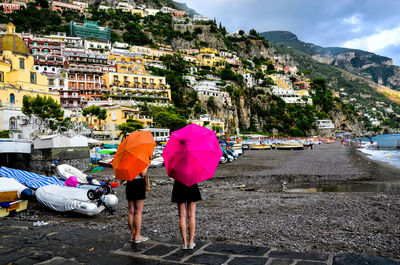 Rear view of people walking on mountain in city