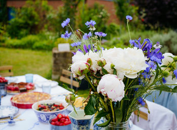 Summer flowers bouquet on the festive table outdoor party