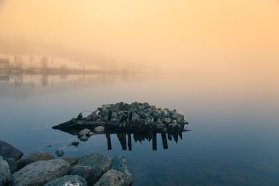 Scenic view of lake against sky during sunset