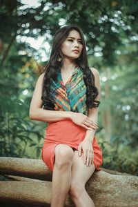 Portrait of young woman sitting outdoors