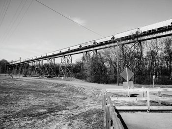 Bridge over field against sky