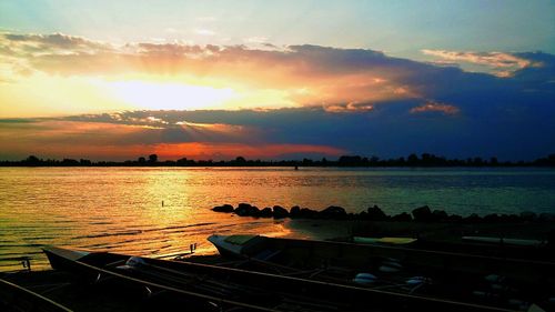 Boats in sea during sunset