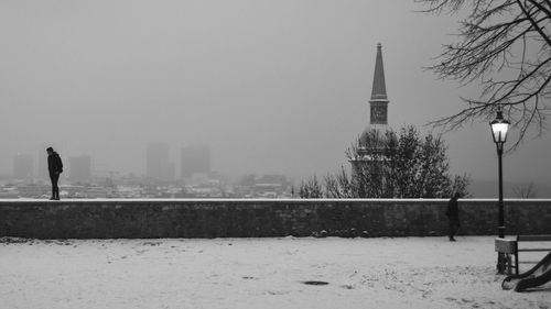 View of snow covered buildings against sky