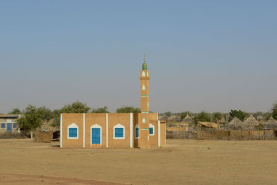 Built structure on beach against clear sky